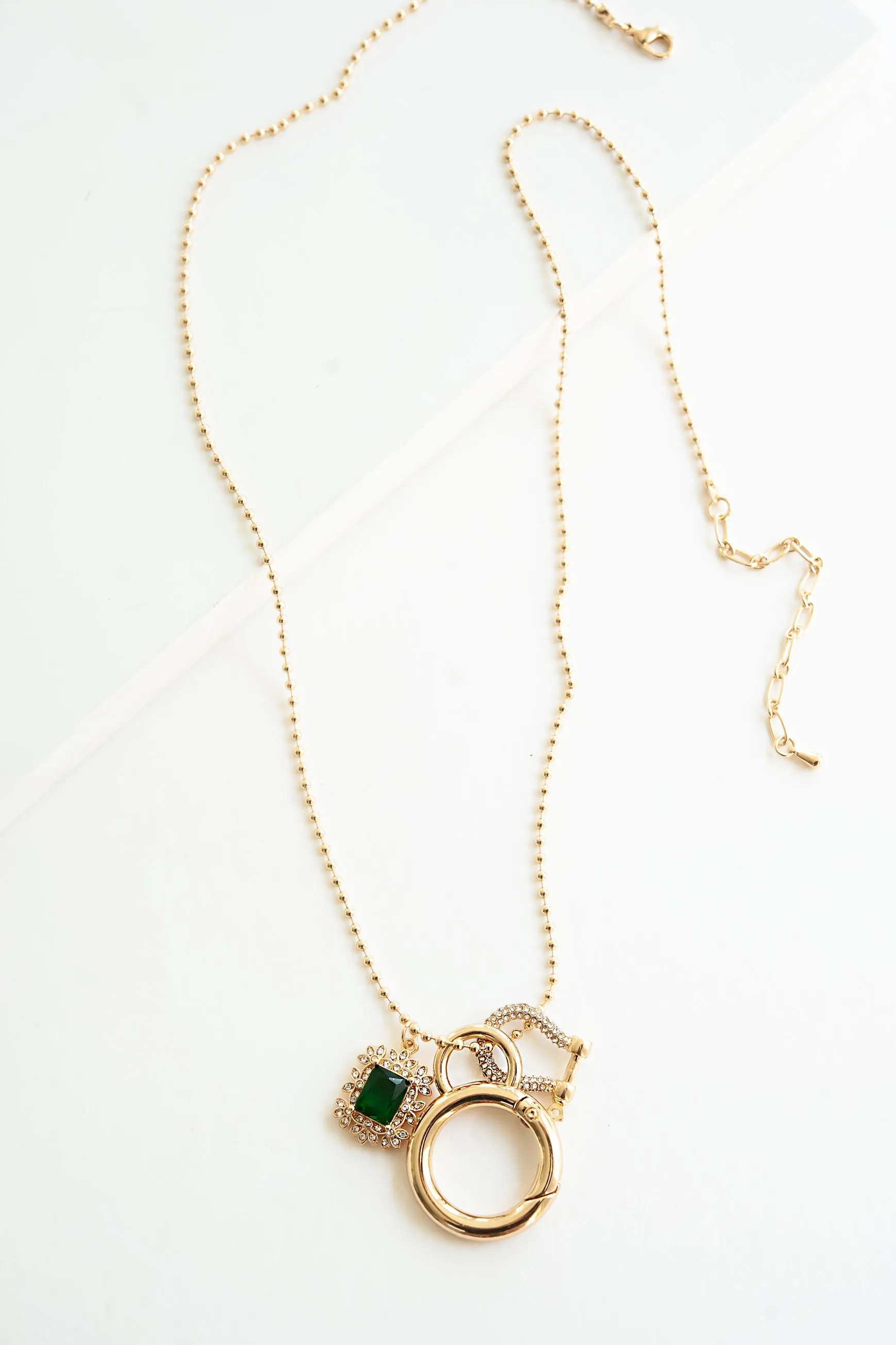 Eve Long Emerald Pendant Necklace | Long Gold Chain with Gold Horseshoe and Emerald Crystal Pendant Charms